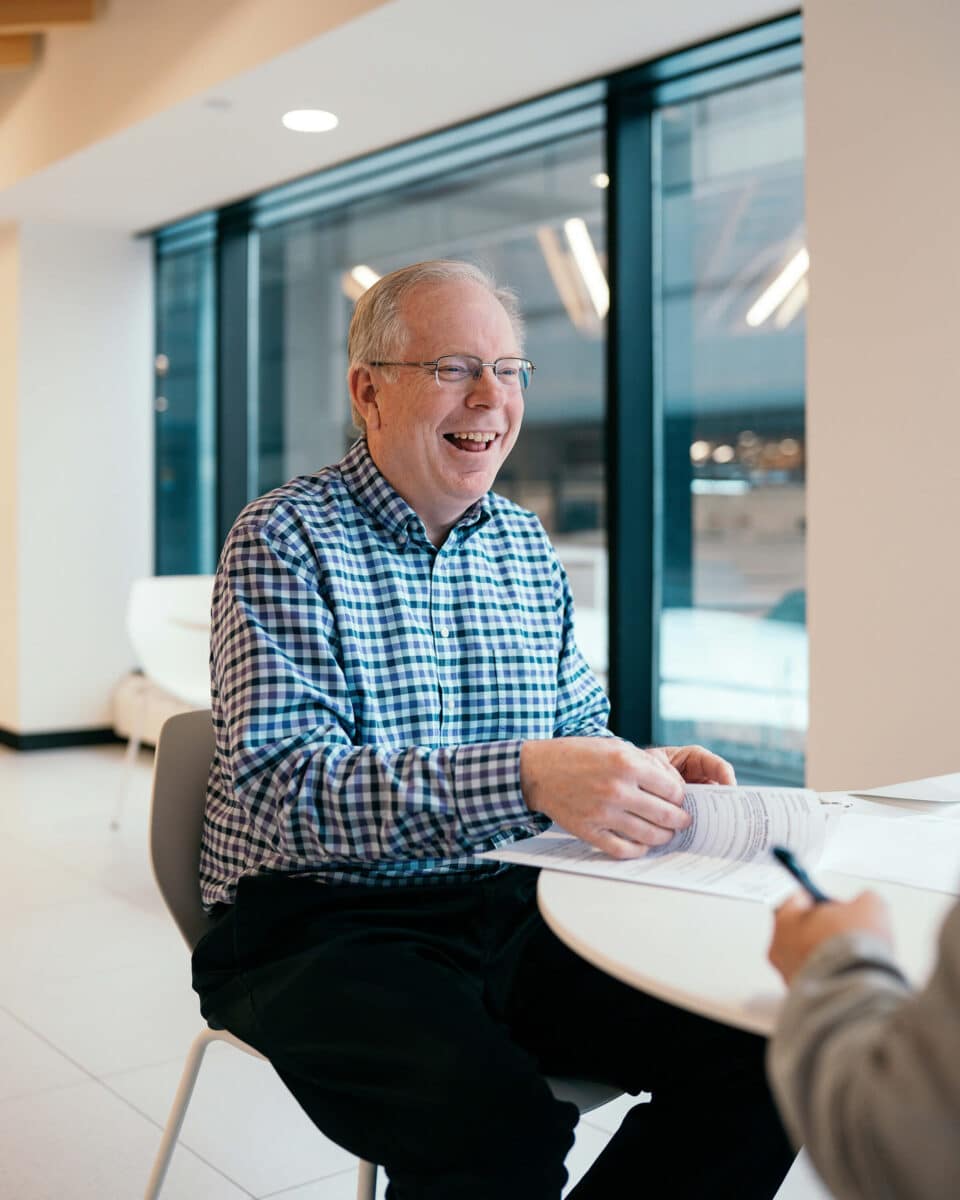 Man smiling at computer screen