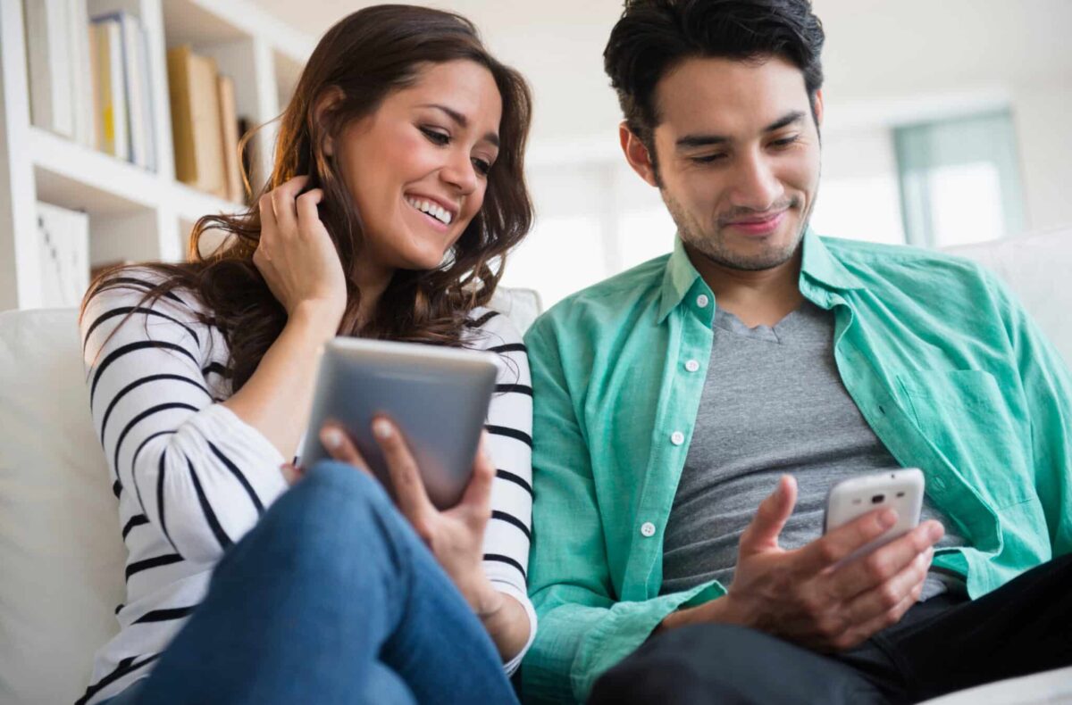 Couple looking at devices