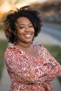 Woman with arms crossed smiling
