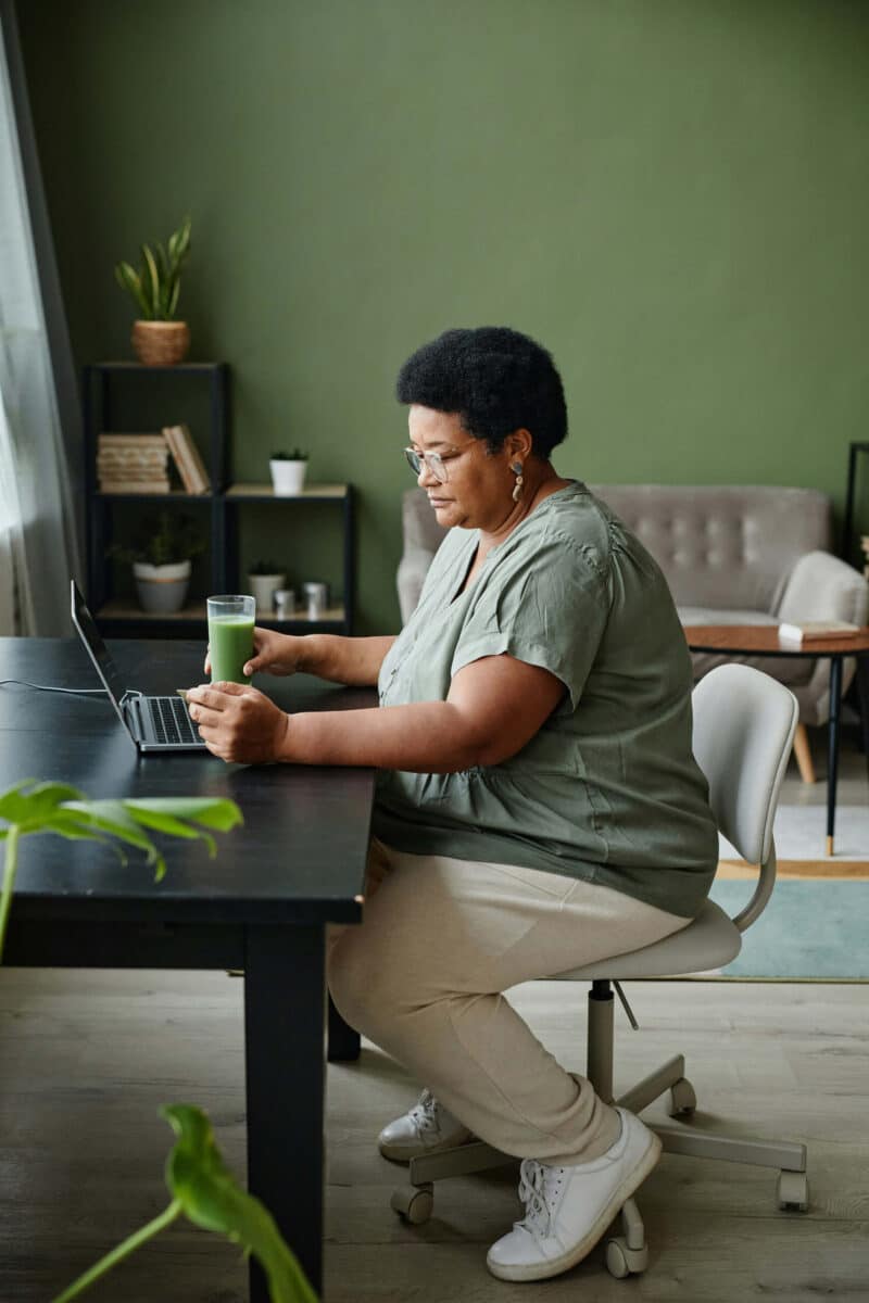 Woman sitting at computer paying bill