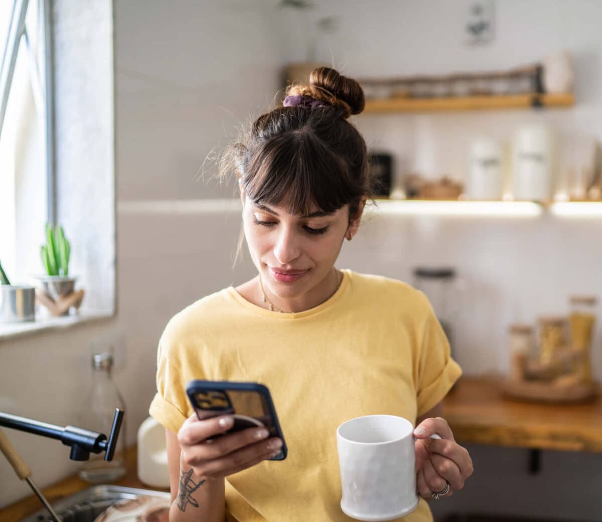 Woman on phone drinking coffee