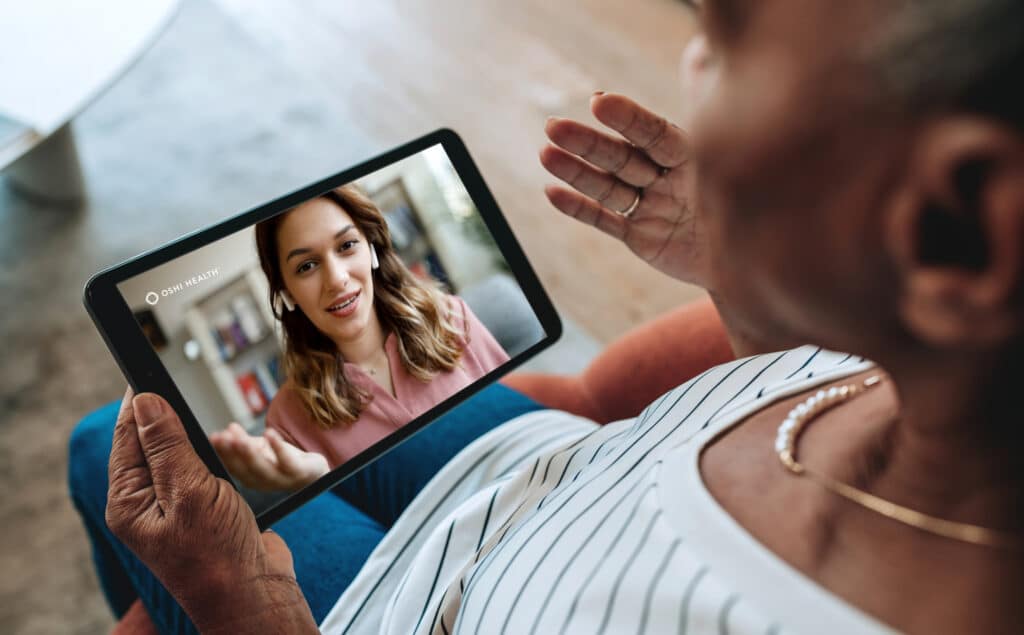 woman with ipad connecting virtually with care coordinator