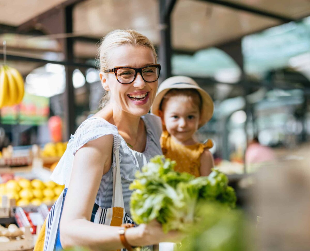 Happy mother shopping at farmer's market